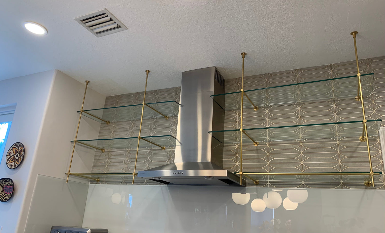 Custom ceiling and wall mounted solid brass commercial shelving, brushed brass, Dallas, TX