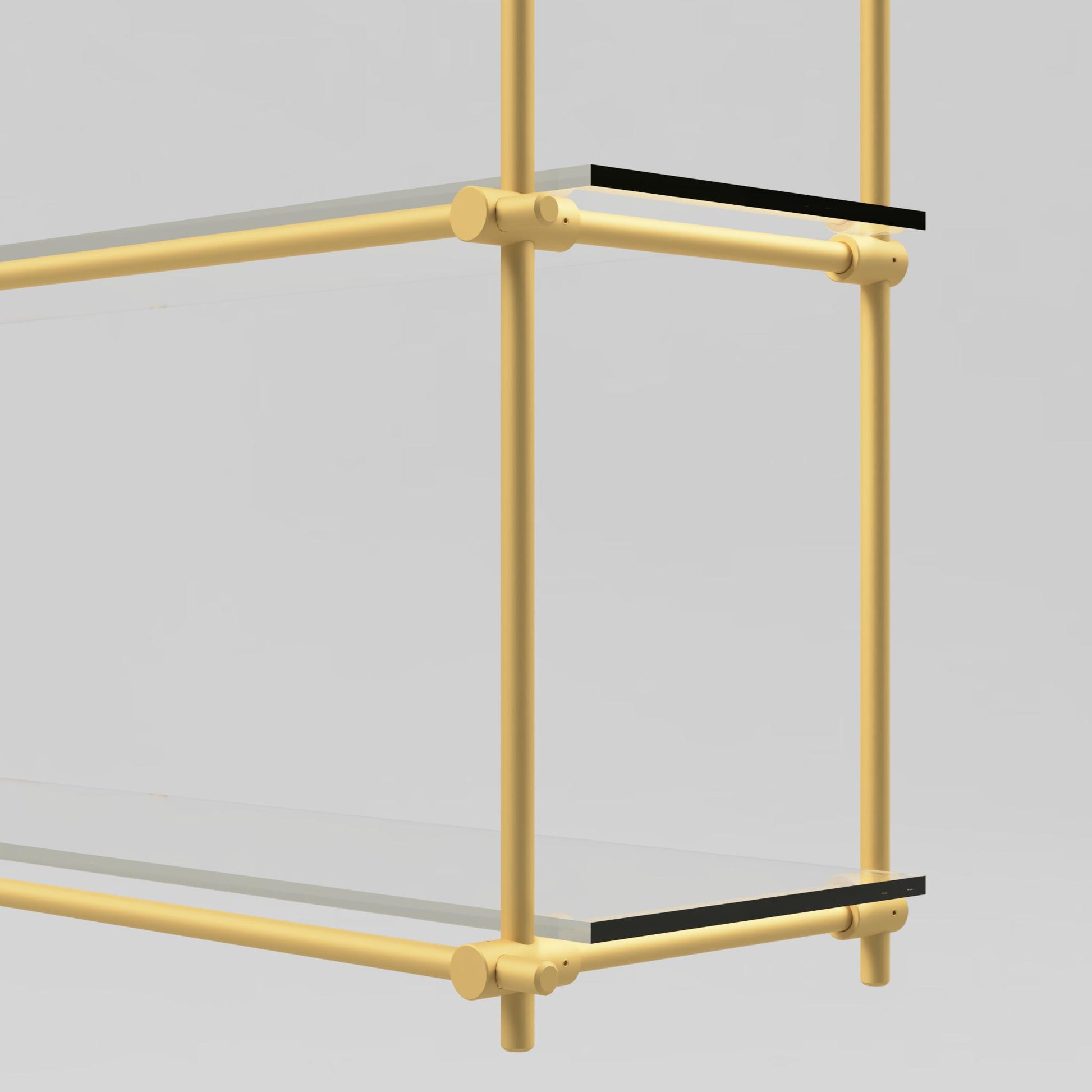 Close-up view of the brass and glass shelving unit, highlighting the brass support bars and glass shelf detail.